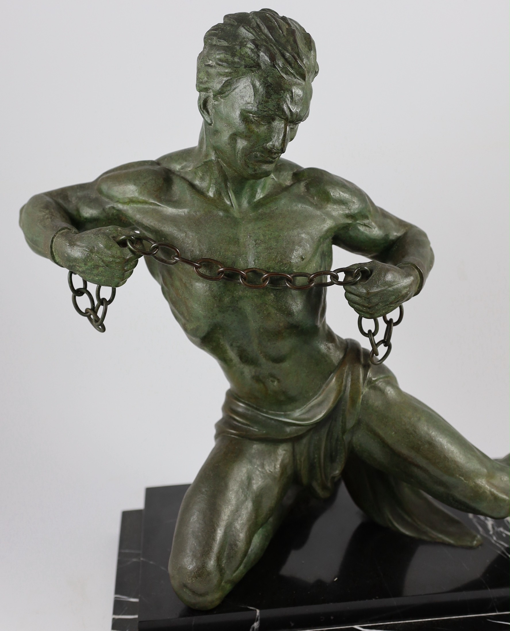 Jean De Roncourt. A French Art Deco bronze 'Hercule brisant ses chaînes', 50cm high 61cm long